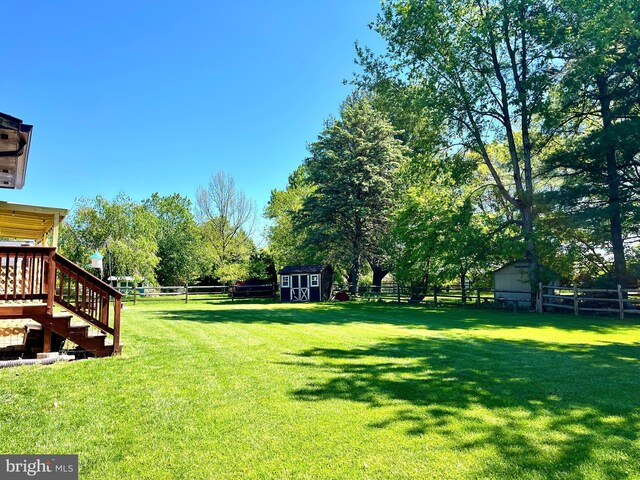 8117 Glendale Dr, Frederick, MD 21702 - fenced backyard featuring a storage shed, stairs, and a wooden deck