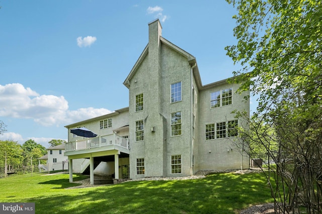 1311 Meadowbrook Ct, Jenkintown, PA 19046 - rear view of property featuring stucco siding, a deck, a lawn, and a chimney