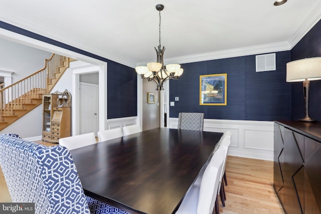 1311 Meadowbrook Ct, Jenkintown, PA 19046 - dining space with a chandelier, stairs, light wood-style floors, wainscoting, and crown molding