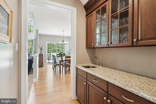 1311 Meadowbrook Ct, Jenkintown, PA 19046 - bar with a sink, light wood-style flooring, a chandelier, and baseboards
