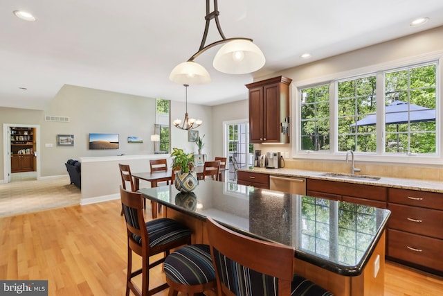 1311 Meadowbrook Ct, Jenkintown, PA 19046 - kitchen with stainless steel dishwasher, a sink, a chandelier, hanging light fixtures, and light wood-style flooring
