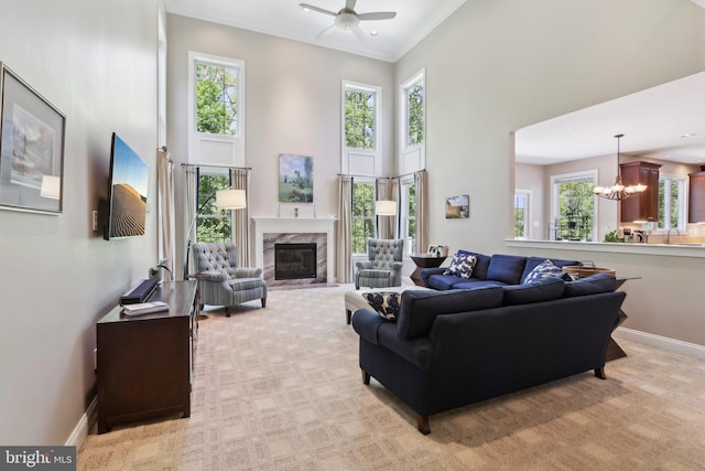 1311 Meadowbrook Ct, Jenkintown, PA 19046 - living room featuring a high ceiling, a chandelier, a fireplace, a ceiling fan, and light carpet
