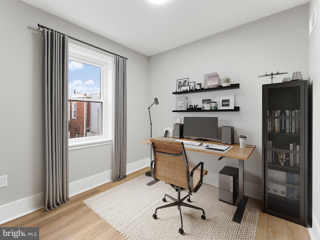 office with wood finished floors and baseboards