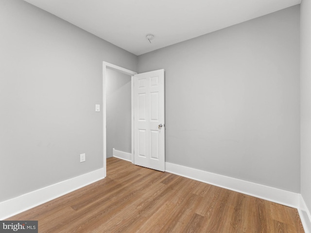 empty room featuring light wood-style floors and baseboards