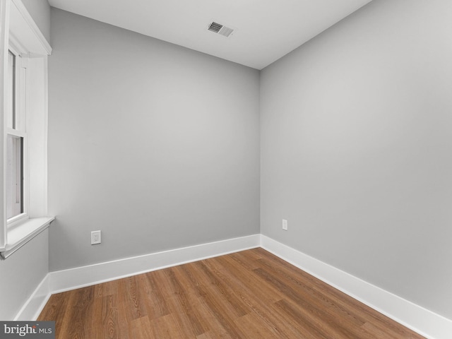 unfurnished room with wood finished floors and baseboards