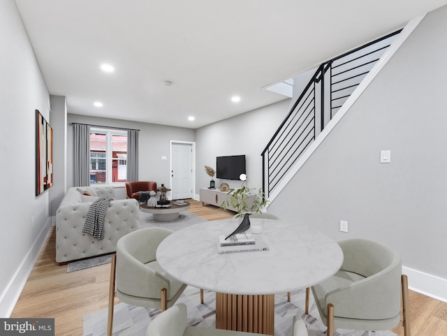 dining room with stairway, light wood finished floors, baseboards, and recessed lighting