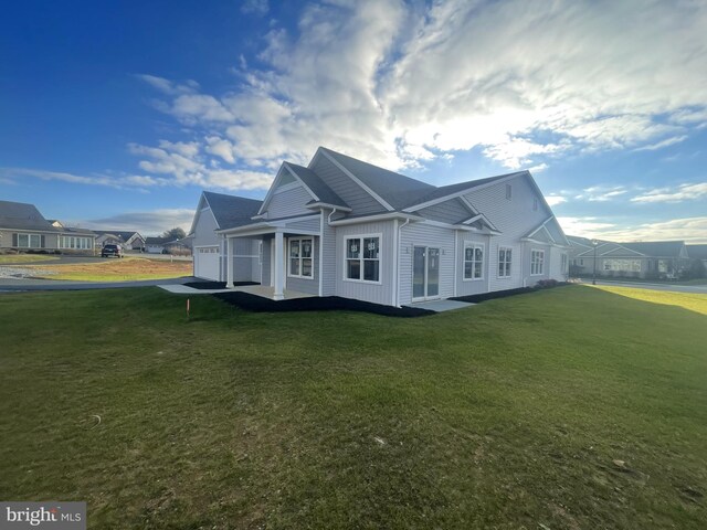 90 S Village Cir Unit 240, Palmyra, PA 17078 - view of side of property featuring an attached garage, a yard, and board and batten siding