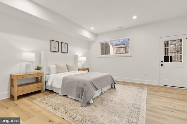 bedroom featuring light wood-type flooring, recessed lighting, and baseboards
