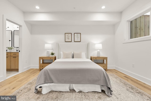 bedroom featuring light wood-type flooring, baseboards, connected bathroom, and recessed lighting