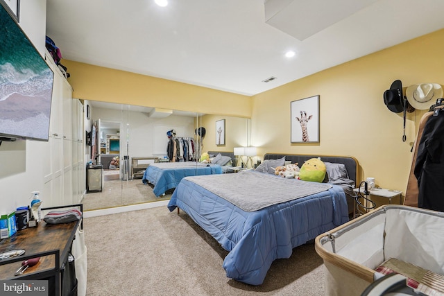 carpeted bedroom with recessed lighting