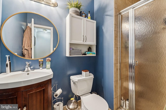 full bathroom with a stall shower, toilet, and vanity