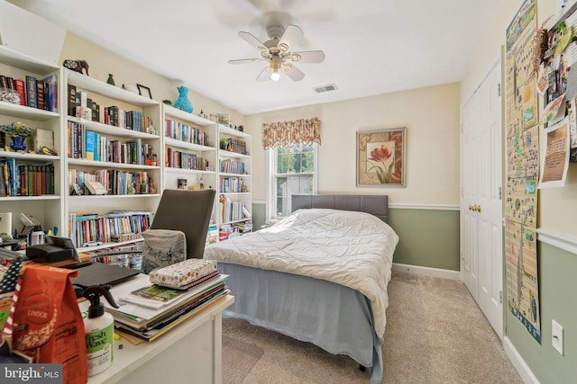 carpeted bedroom featuring baseboards and a ceiling fan