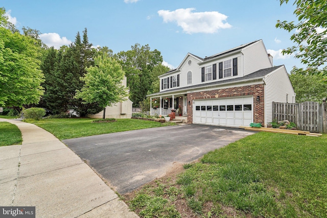 traditional-style home featuring brick siding, driveway, and a garage