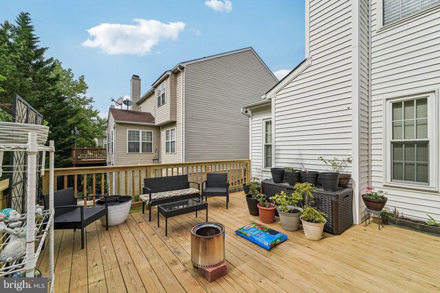 wooden deck featuring an outdoor hangout area