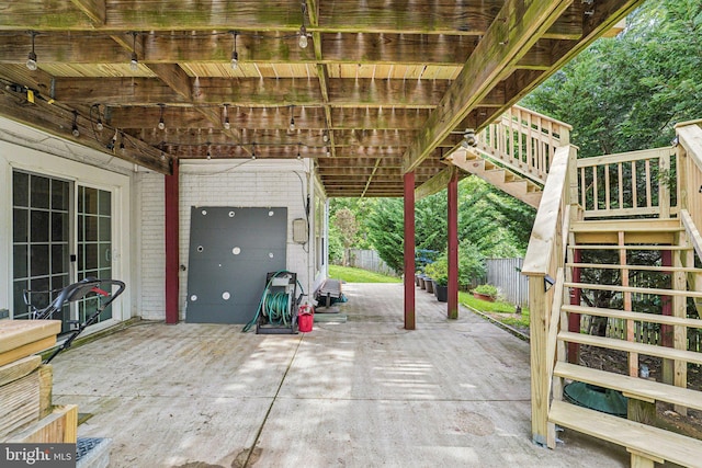 view of patio / terrace with stairway and fence