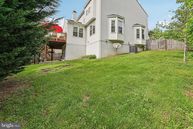 view of yard featuring a wooden deck and central AC unit