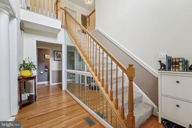 stairs with wood finished floors and baseboards