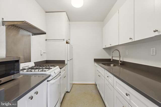5112 Macarthur Blvd NW Unit 104, Washington, DC 20016 - kitchen with white appliances, a sink, dark countertops, white cabinets, and baseboards