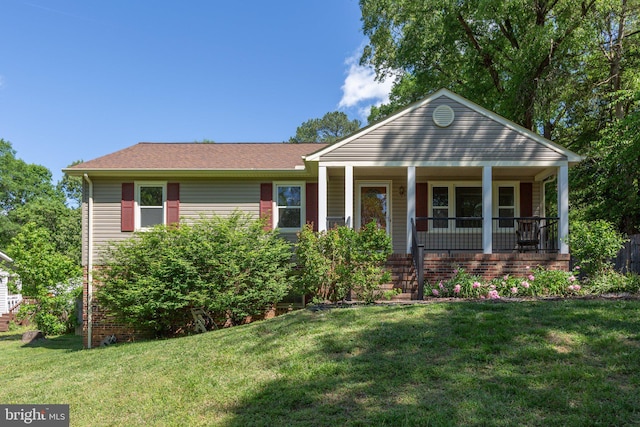 view of front of house featuring covered porch, a front yard, and roof with shingles