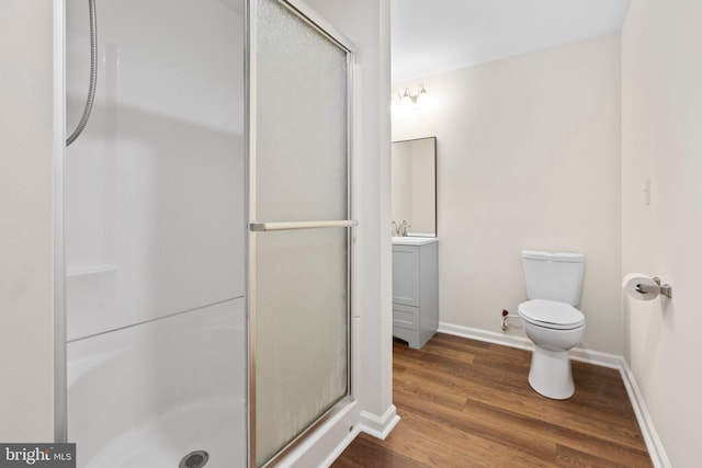 910 Ficklen Rd, Fredericksburg, VA 22405 - full bathroom featuring a stall shower, wood finished floors, toilet, vanity, and baseboards