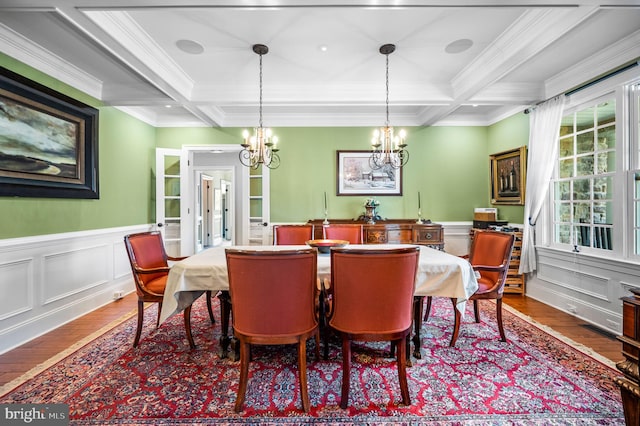 211 Dutton Mill Rd, West Chester, PA 19380 - dining area featuring wood-type flooring, a chandelier, crown molding, a decorative wall, and wainscoting