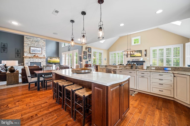 211 Dutton Mill Rd, West Chester, PA 19380 - kitchen with a fireplace, dishwasher, dark wood-style floors, a breakfast bar, and lofted ceiling