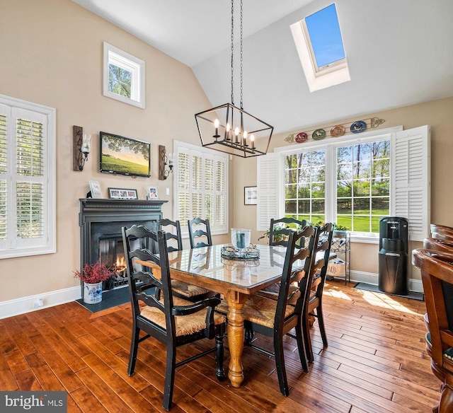 211 Dutton Mill Rd, West Chester, PA 19380 - dining space featuring high vaulted ceiling, a skylight, a chandelier, healthy amount of natural light, and baseboards