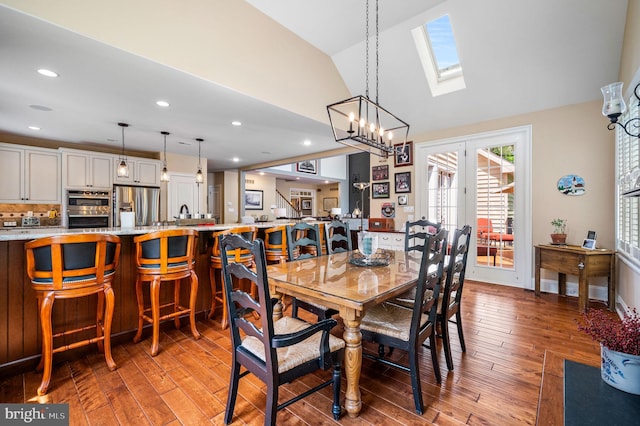 211 Dutton Mill Rd, West Chester, PA 19380 - dining room with light wood finished floors, a skylight, recessed lighting, a chandelier, and high vaulted ceiling