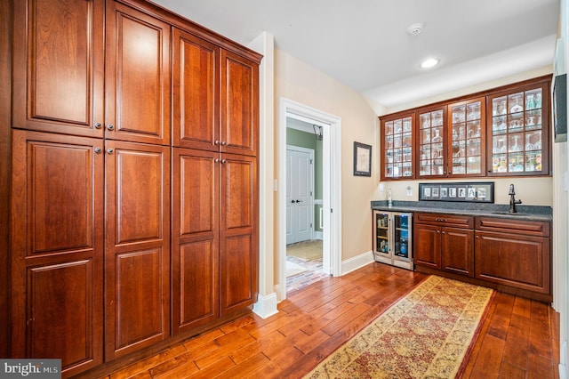 211 Dutton Mill Rd, West Chester, PA 19380 - indoor bar featuring dark wood-type flooring, wine cooler, recessed lighting, and baseboards