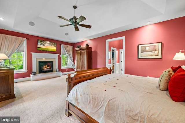 211 Dutton Mill Rd, West Chester, PA 19380 - carpeted bedroom with a raised ceiling, a glass covered fireplace, recessed lighting, and baseboards