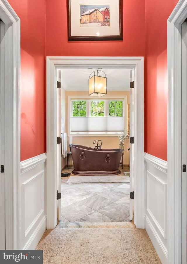 211 Dutton Mill Rd, West Chester, PA 19380 - bathroom featuring a decorative wall, a freestanding tub, wainscoting, crown molding, and marble finish floors