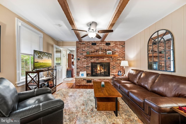 211 Dutton Mill Rd, West Chester, PA 19380 - living area featuring wood finished floors, ceiling fan, beam ceiling, and a brick fireplace