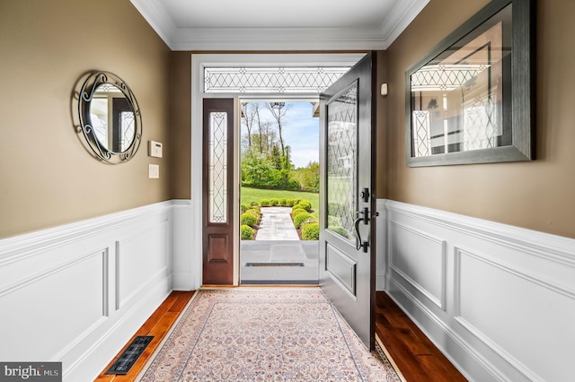 211 Dutton Mill Rd, West Chester, PA 19380 - foyer entrance featuring dark wood-style flooring, crown molding, wainscoting, and a decorative wall