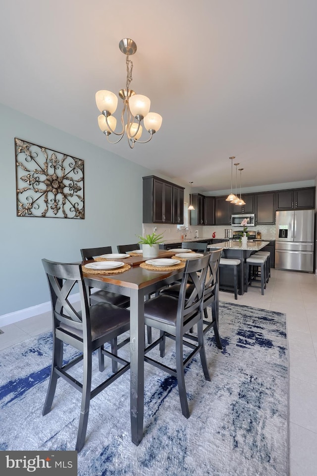dining space with a chandelier and light tile patterned floors