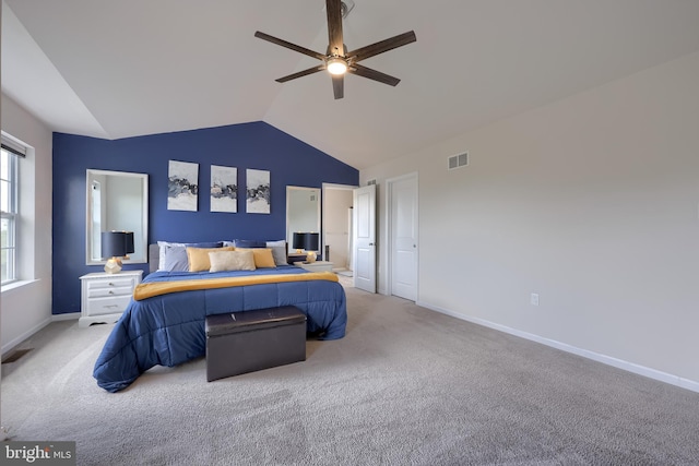 bedroom featuring lofted ceiling, light colored carpet, baseboards, and a ceiling fan