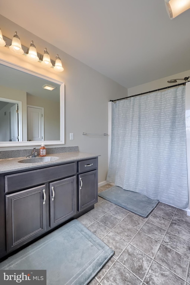 bathroom with vanity, tile patterned floors, and curtained shower