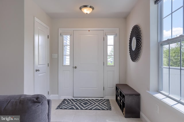 entrance foyer featuring tile patterned flooring and baseboards