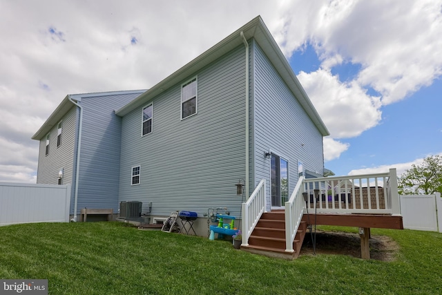 rear view of property with a deck, central AC unit, and stairway
