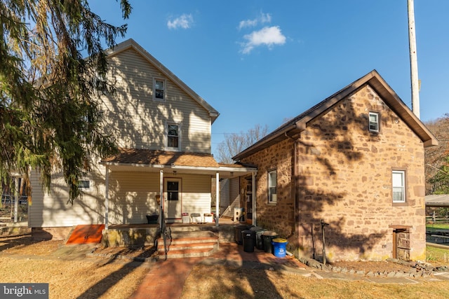 rear view of house with covered porch