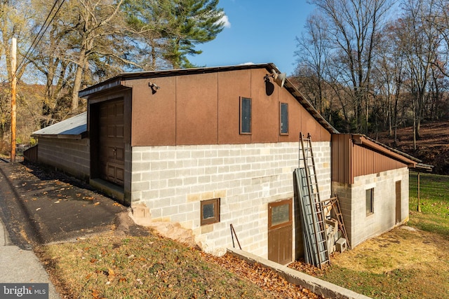 view of property exterior with concrete block siding