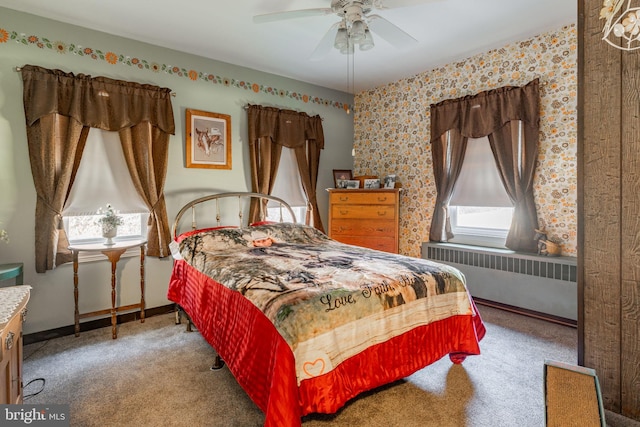 carpeted bedroom with radiator heating unit and ceiling fan