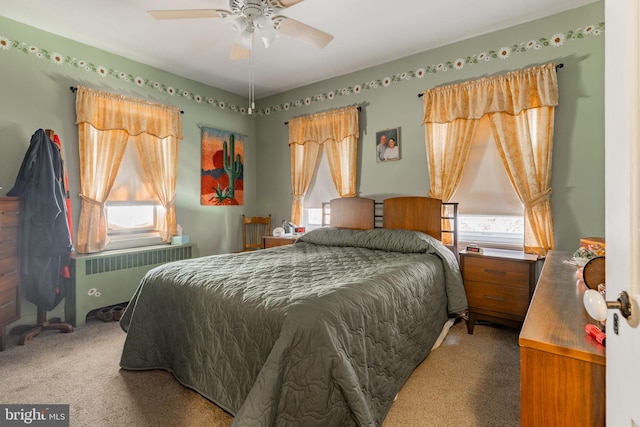 bedroom with radiator, carpet flooring, and multiple windows