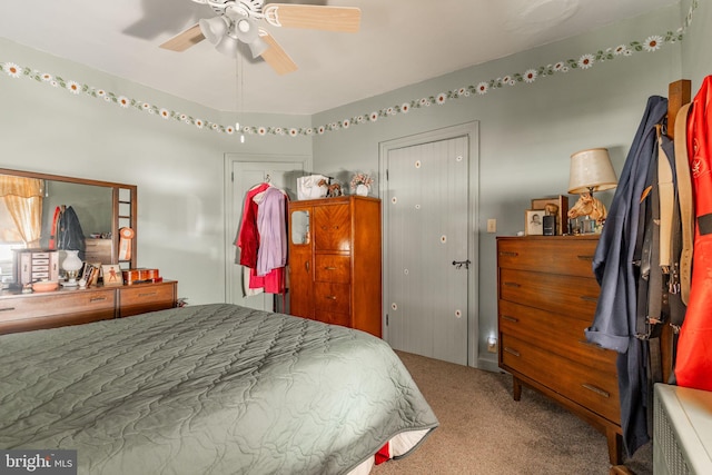 carpeted bedroom featuring a closet and a ceiling fan