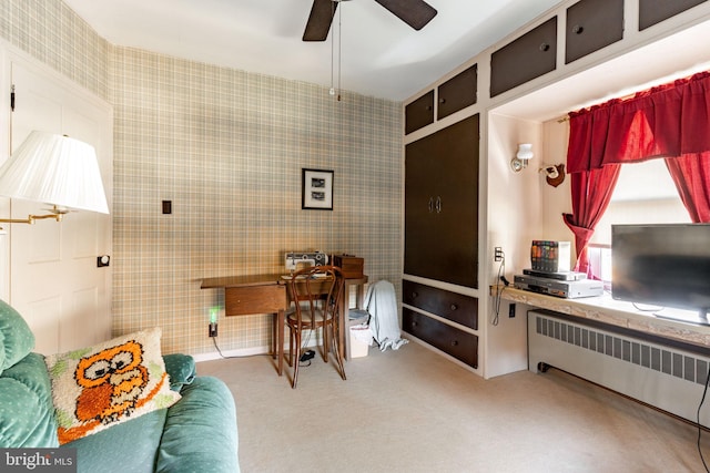 office space with radiator heating unit, a ceiling fan, and carpet floors