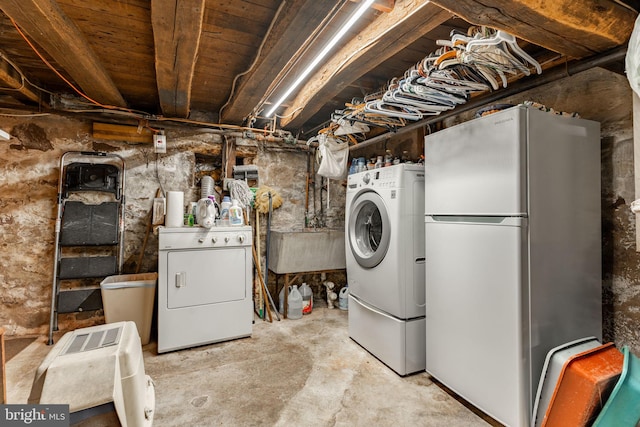 clothes washing area with washer and dryer