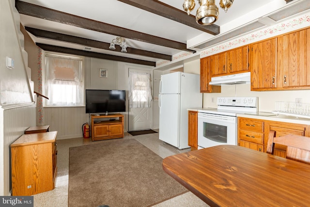 kitchen featuring under cabinet range hood, white appliances, beamed ceiling, light countertops, and brown cabinetry