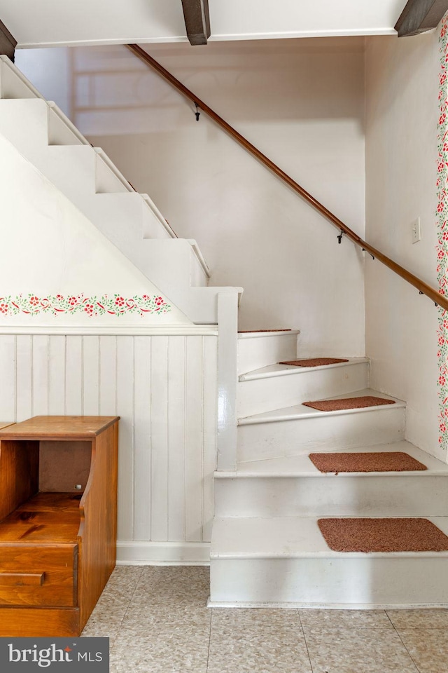stairway with tile patterned floors