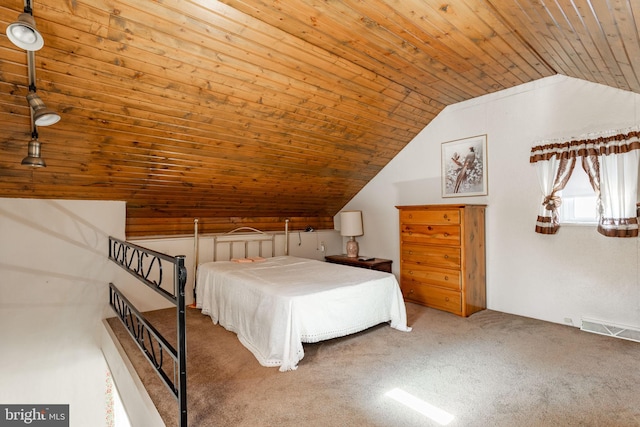 bedroom featuring vaulted ceiling, wood ceiling, and carpet floors