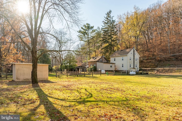 view of yard featuring an outbuilding and a storage shed
