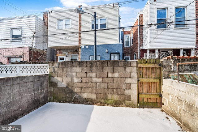 view of property exterior with fence and a gate